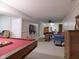 Recreational basement area with pool table, seating area, and entertainment center perfect for hosting gatherings and relaxation at 1737 Friendship Dr, Indianapolis, IN 46217