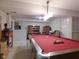 Basement rec room showcasing a pool table with ample natural light from a nearby window and neutral colored walls at 1737 Friendship Dr, Indianapolis, IN 46217