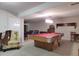 Spacious basement featuring a pool table, chair, and various seating options for entertaining in a roomy environment at 1737 Friendship Dr, Indianapolis, IN 46217