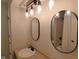 A bathroom with modern lighting, mirrors, and a marble countertop at 1737 Friendship Dr, Indianapolis, IN 46217