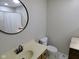 Clean and functional bathroom with a white toilet, sink, and mirror, providing essential amenities at 1737 Friendship Dr, Indianapolis, IN 46217