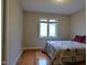 Bedroom with wood floors, neutral paint, and a window at 1737 Friendship Dr, Indianapolis, IN 46217