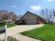 Charming home with a brick exterior, attached garage, and well-manicured lawn offers curb appeal and convenience at 1737 Friendship Dr, Indianapolis, IN 46217