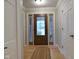 Inviting foyer with a decorative front door, hardwood floors, and white trim at 1737 Friendship Dr, Indianapolis, IN 46217
