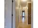 Hallway with wood floors, neutral paint and white trim, leading to a door at the end at 1737 Friendship Dr, Indianapolis, IN 46217
