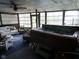 Enclosed patio featuring a hot tub, a ceiling fan, and wicker furniture, creating a comfortable outdoor relaxation space at 1737 Friendship Dr, Indianapolis, IN 46217
