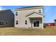 View of the back of the house with sliding glass door and covered back patio at 2252 Marjorie Way, Shelbyville, IN 46176