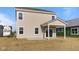 View of the back of the house with sliding glass door and covered back patio at 2252 Marjorie Way, Shelbyville, IN 46176