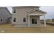 Back of home featuring covered patio and large sliding glass doors to backyard at 2252 Marjorie Way, Shelbyville, IN 46176