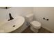 Bathroom featuring a toilet, matte black fixtures, and modern white pedestal sink at 2252 Marjorie Way, Shelbyville, IN 46176