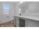 This bathroom is equipped with a modern vanity, large mirror, wood-style flooring and ample lighting at 2252 Marjorie Way, Shelbyville, IN 46176