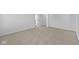 Large bedroom with neutral carpeting, white walls, and two doors at 2252 Marjorie Way, Shelbyville, IN 46176