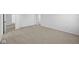 Large bedroom with neutral carpeting, white walls, and a doorway into another room at 2252 Marjorie Way, Shelbyville, IN 46176