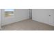 Bright bedroom with neutral carpet and window overlooking greenery at 2252 Marjorie Way, Shelbyville, IN 46176