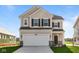 Beautiful two-story home with a two-car garage, manicured lawn, and classic architectural details at 2252 Marjorie Way, Shelbyville, IN 46176