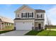 Charming two-story home featuring neutral siding, black shutters, and an attached two-car garage at 2252 Marjorie Way, Shelbyville, IN 46176