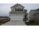Two-story home with a two-car garage, neutral siding, black shutters and modern fixtures at 2252 Marjorie Way, Shelbyville, IN 46176