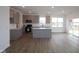 Open concept kitchen with a kitchen island, grey cabinets, and stainless steel appliances at 2252 Marjorie Way, Shelbyville, IN 46176