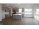 Bright open concept kitchen with an island, grey cabinets, and stainless steel appliances at 2252 Marjorie Way, Shelbyville, IN 46176