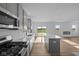 Modern kitchen offering stainless appliances, an island with seating, and easy access to the living area at 2252 Marjorie Way, Shelbyville, IN 46176