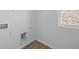 This laundry room has wood style vinyl flooring and is equipped with utility hookups at 2252 Marjorie Way, Shelbyville, IN 46176