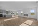 Spacious living room showcasing luxury vinyl plank flooring, a modern fireplace, and natural light at 2252 Marjorie Way, Shelbyville, IN 46176