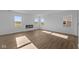Open-concept living room features luxury vinyl plank floors, fireplace, and lots of natural light at 2252 Marjorie Way, Shelbyville, IN 46176
