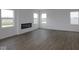 Living room featuring an electric fireplace, modern floors, white walls, and bright windows at 2252 Marjorie Way, Shelbyville, IN 46176