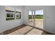 The room is equipped with wood style vinyl flooring and a sliding glass door at 2252 Marjorie Way, Shelbyville, IN 46176
