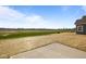 Spacious backyard features a concrete patio and serene green field views at 2268 Marjorie Way, Shelbyville, IN 46176