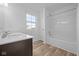 A bright bathroom features a double vanity with white countertop and shower with tub at 2268 Marjorie Way, Shelbyville, IN 46176