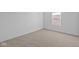 Bright, carpeted bedroom showcases a neutral palette and a sunlit window at 2268 Marjorie Way, Shelbyville, IN 46176
