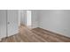 Empty bedroom features light plank flooring, neutral paint and two access doors at 2268 Marjorie Way, Shelbyville, IN 46176
