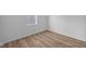 Cozy bedroom with wood-look floors, natural light, and a fresh, clean aesthetic at 2268 Marjorie Way, Shelbyville, IN 46176