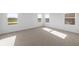 A bright bedroom features neutral carpet, white walls, and sunlit windows with views at 2268 Marjorie Way, Shelbyville, IN 46176