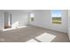 A bright bedroom features neutral carpet, white walls, and sunlit windows with views at 2268 Marjorie Way, Shelbyville, IN 46176