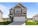 Charming two-story home featuring a two-car garage, neat landscaping, and a classic design at 2268 Marjorie Way, Shelbyville, IN 46176