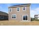 Back exterior features neutral siding, white trim, sliding door, and large windows at 2268 Marjorie Way, Shelbyville, IN 46176