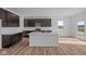 Bright kitchen features stainless steel appliances, island with sink, and sliding glass doors at 2268 Marjorie Way, Shelbyville, IN 46176