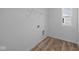A simple laundry room features wood-look flooring, white walls, and wire shelving at 2268 Marjorie Way, Shelbyville, IN 46176