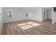 Large, bright living area with wood-look flooring and multiple windows for ample natural light at 2268 Marjorie Way, Shelbyville, IN 46176
