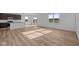 Open-concept living room with wood-look flooring, lots of windows and great sunlight at 2268 Marjorie Way, Shelbyville, IN 46176