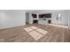 Spacious living area with views to the kitchen, features wood-look floors and ample natural light at 2268 Marjorie Way, Shelbyville, IN 46176