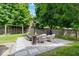 Backyard with a cozy seating area, swing set, lush greenery, and a privacy fence at 244 W Admiral S Way, Carmel, IN 46032