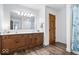 Bathroom features a double sink vanity with wood cabinets, stylish fixtures, and plank flooring at 244 W Admiral S Way, Carmel, IN 46032