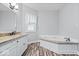 Bathroom featuring double vanity with granite counter tops and tub at 244 W Admiral S Way, Carmel, IN 46032