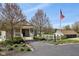 Charming clubhouse entrance with stone facade, leading to a pool area and American flag at 244 W Admiral S Way, Carmel, IN 46032