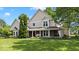 Charming two-story home boasting a large front porch and a well-manicured lawn under a beautiful blue sky at 244 W Admiral S Way, Carmel, IN 46032