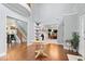 Grand foyer featuring hardwood floors, a striking staircase, and an elegant round table at 244 W Admiral S Way, Carmel, IN 46032