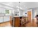 Well-equipped kitchen featuring a granite island with seating, stainless steel appliances, and ample storage at 244 W Admiral S Way, Carmel, IN 46032